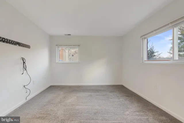a view of room with window and air conditioner