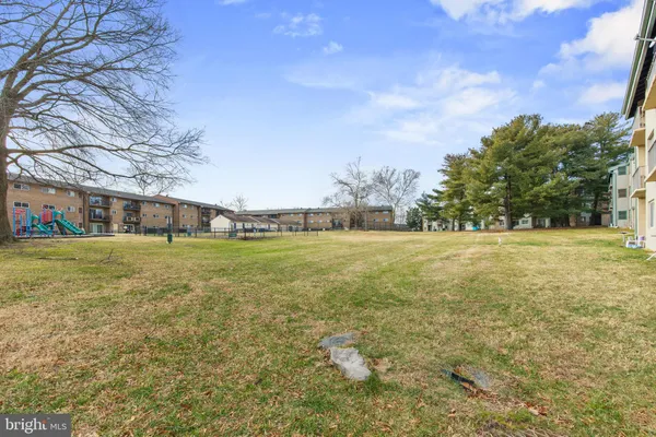 a view of green field with house in the background