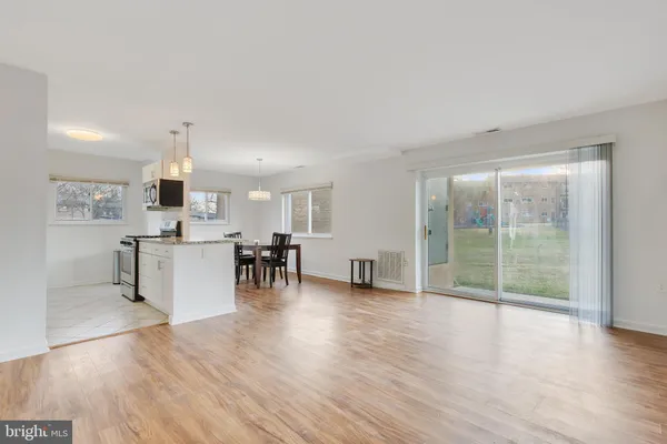 a view of kitchen with furniture and wooden floor