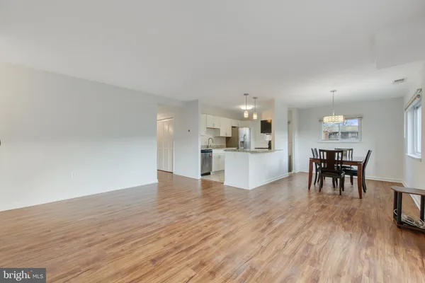 a view of kitchen with furniture and wooden floor