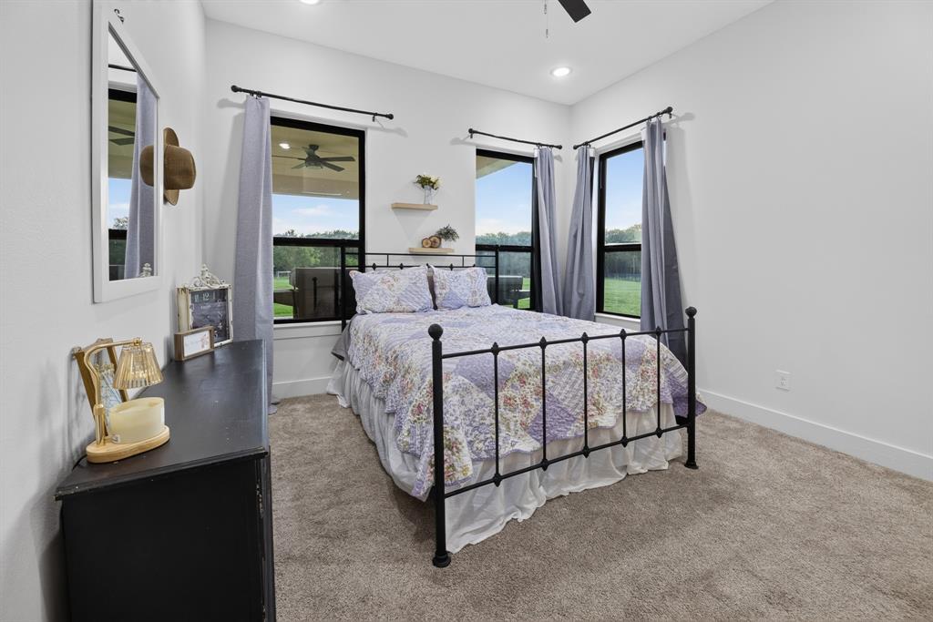 985 Vest Lane Pilot Point, TX 76258 - Photo 30 of 40 Carpeted room featuring multiple windows with black trim, recessed lighting, and a ceiling fan