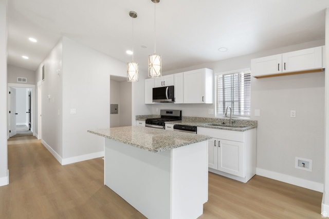 332 Hillgate Way Layton, UT 84041 - Photo 1 of 26 Kitchen with white cabinets, light stone countertops, and stainless steel appliances