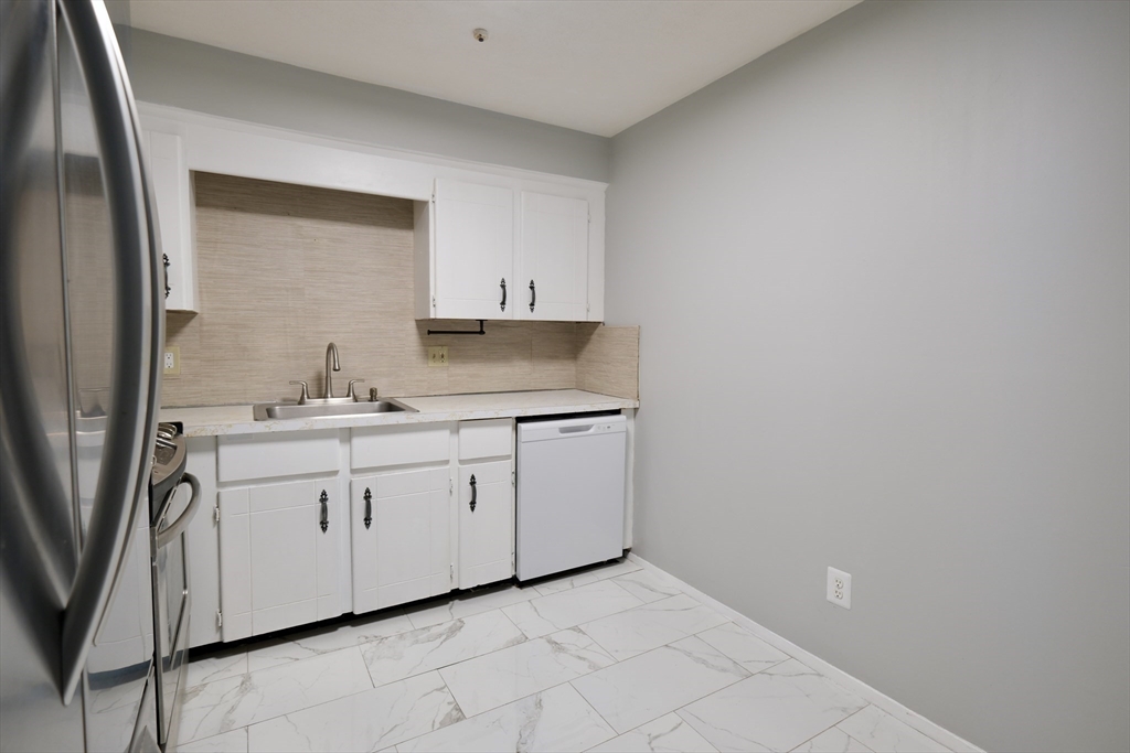 232 Canton Street, Unit 308 Randolph, MA 02368 - Photo 12 of 41 a bathroom with a sink and a mirror