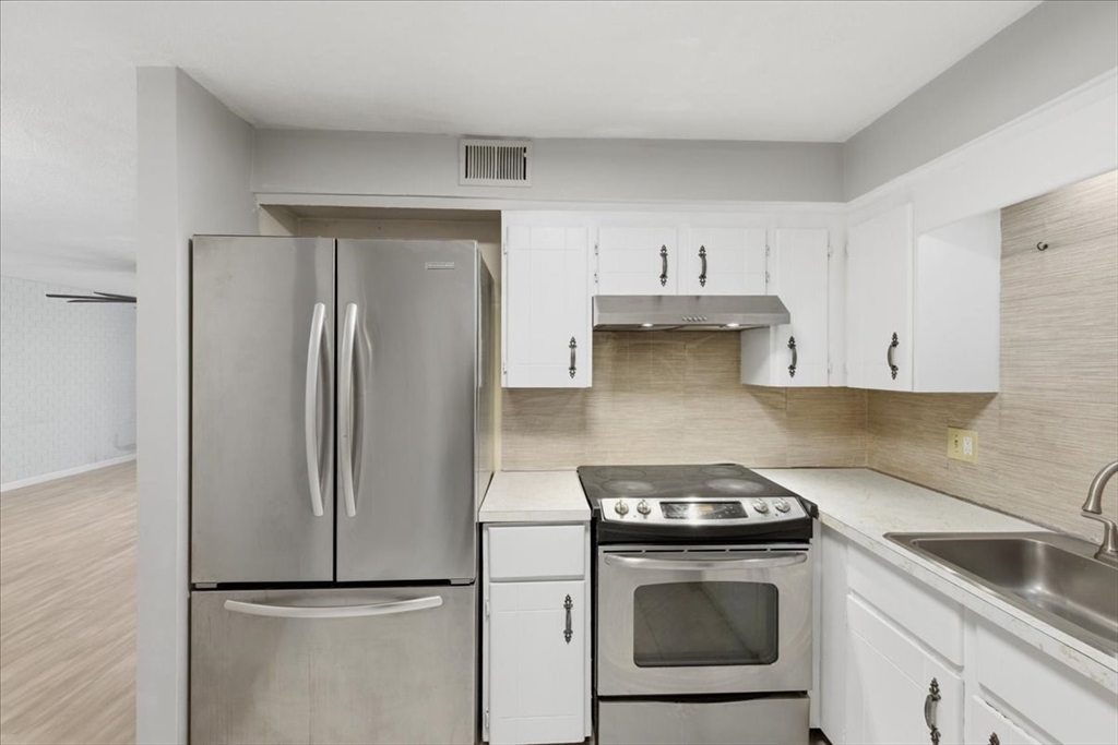 232 Canton Street, Unit 308 Randolph, MA 02368 - Photo 13 of 41 a kitchen with a refrigerator sink and stove top oven