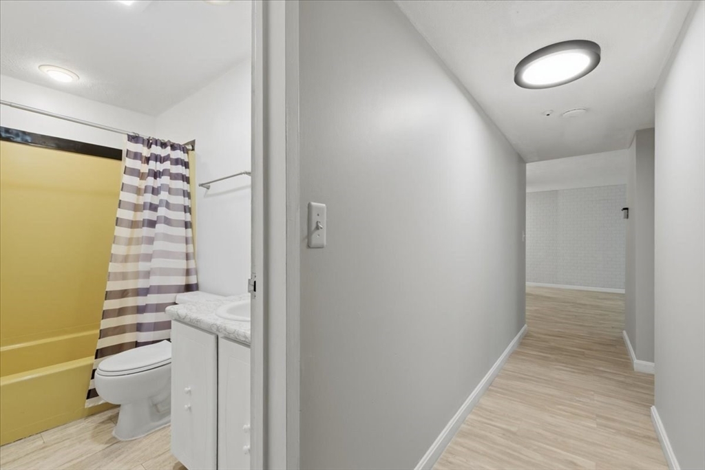 232 Canton Street, Unit 308 Randolph, MA 02368 - Photo 16 of 41 a view of a bathroom with a sink and a mirror