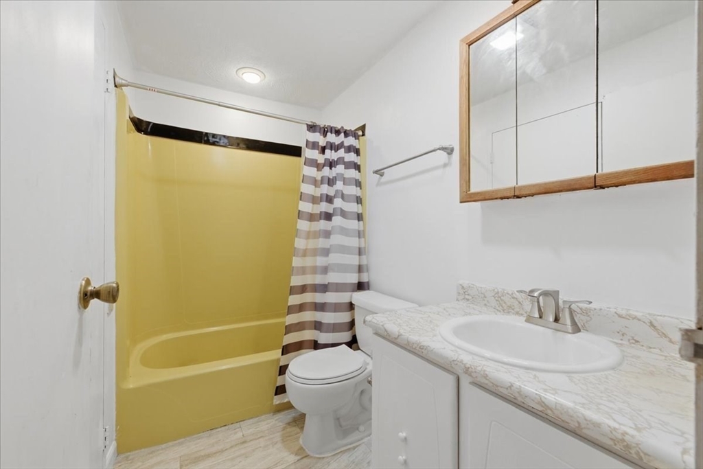 232 Canton Street, Unit 308 Randolph, MA 02368 - Photo 18 of 41 a bathroom with a granite countertop sink toilet and shower