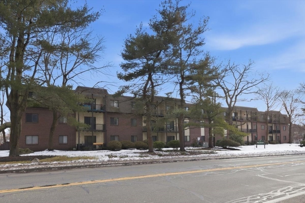 232 Canton Street, Unit 308 Randolph, MA 02368 - Photo 26 of 41 a view of a brick building next to a road