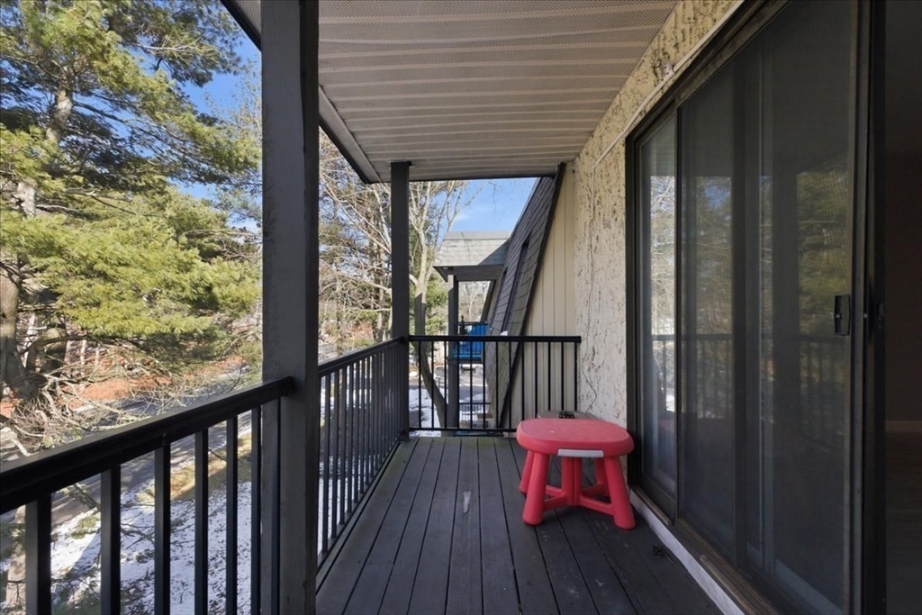 232 Canton Street, Unit 308 Randolph, MA 02368 - Photo 29 of 41 a balcony with wooden floor