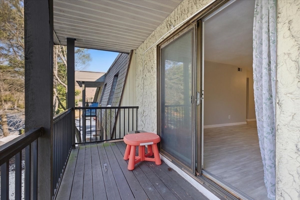 232 Canton Street, Unit 308 Randolph, MA 02368 - Photo 30 of 41 a view of a balcony with wooden floor