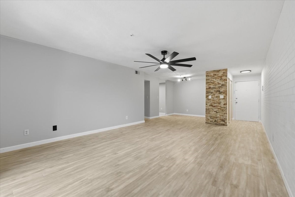 232 Canton Street, Unit 308 Randolph, MA 02368 - Photo 7 of 41 a view of an empty room with wooden floor and a ceiling fan
