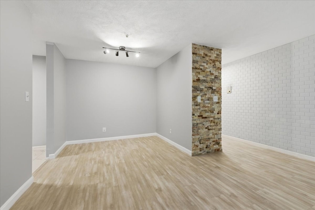232 Canton Street, Unit 308 Randolph, MA 02368 - Photo 8 of 41 wooden floor in a empty room