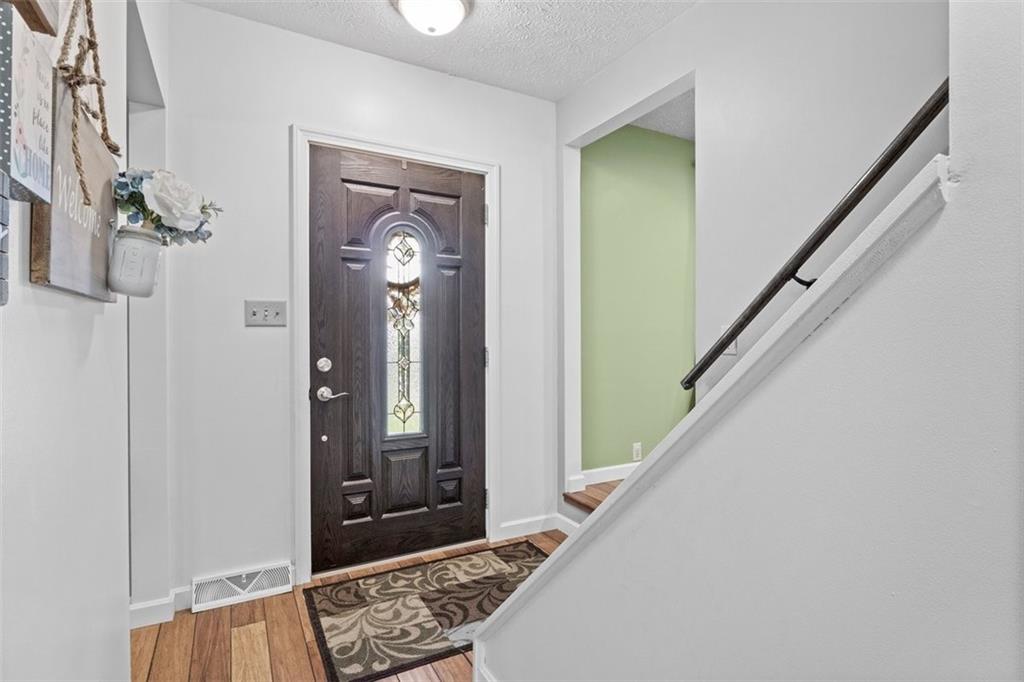 112 Sandy Hill Road Valencia, PA 16059 - Photo 4 of 24 a view of a hallway with wooden floor and stairs