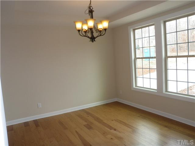 4854 Inwood Road Raleigh, NC 27603 - Photo 3 of 20 Great formal dining room with hardwood floors, tray ceiling, and oil rubbed bronze fixture.