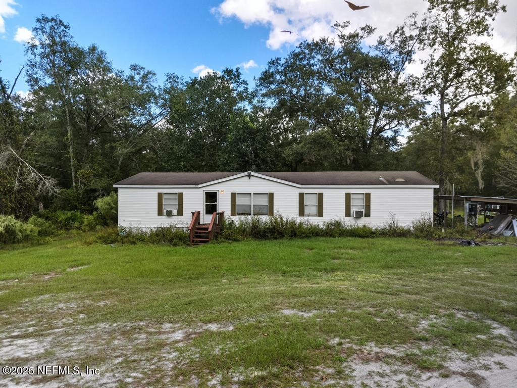 1886 Gentlebreeze Road Middleburg, FL 32068 - Photo 12 of 15 a front view of a house with a garden