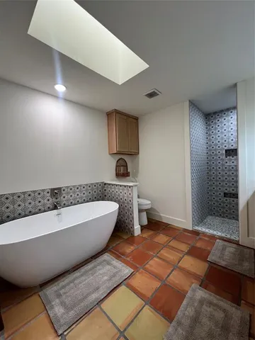 a spacious bathroom with a bathtub and shower