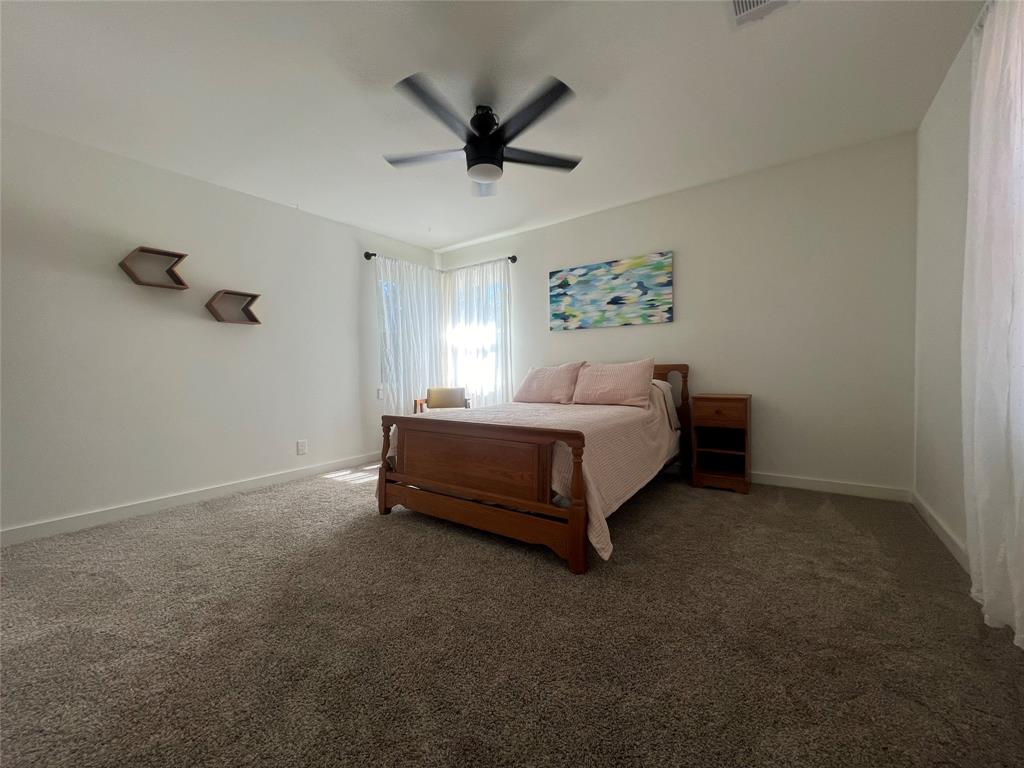5105 Circle Ridge Drive West Fort Worth, TX 76114 - Photo 25 of 32 a spacious bedroom with a bed and a ceiling fan
