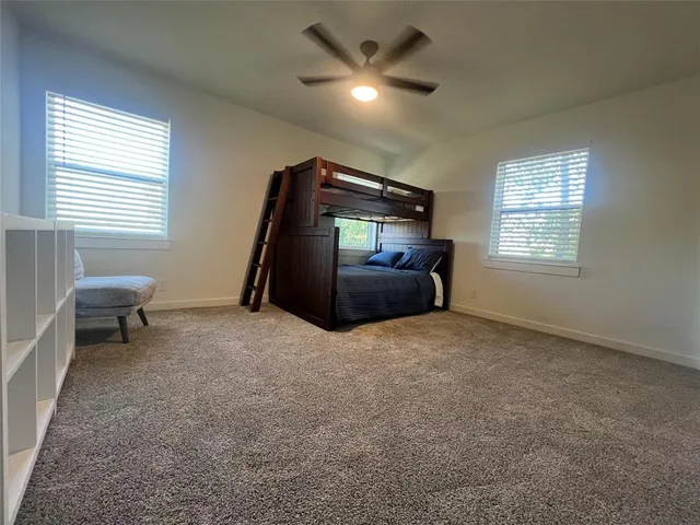 a living room with a bed furniture and a window