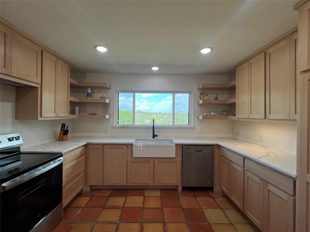 5105 Circle Ridge Drive West Fort Worth, TX 76114 - Photo 5 of 32 a kitchen with a sink dishwasher a stove and white cabinets