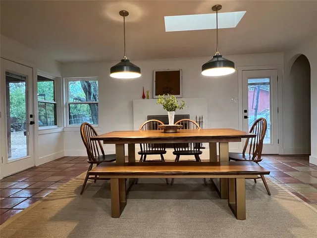 a dining room with furniture window and wooden floor