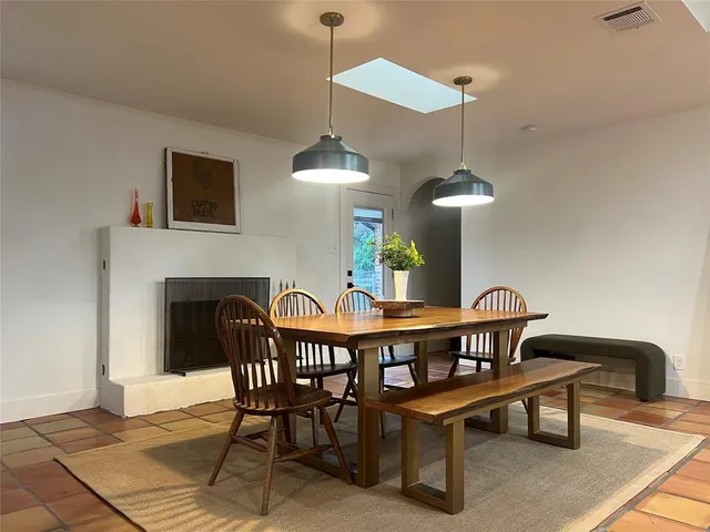 a view of a dining room with furniture and a chandelier