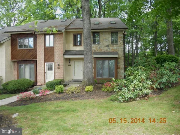 a view of a house with a yard and plants