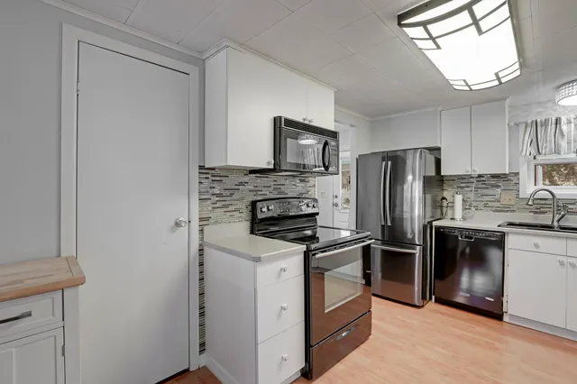 a view of a house with backyard porch and sitting area