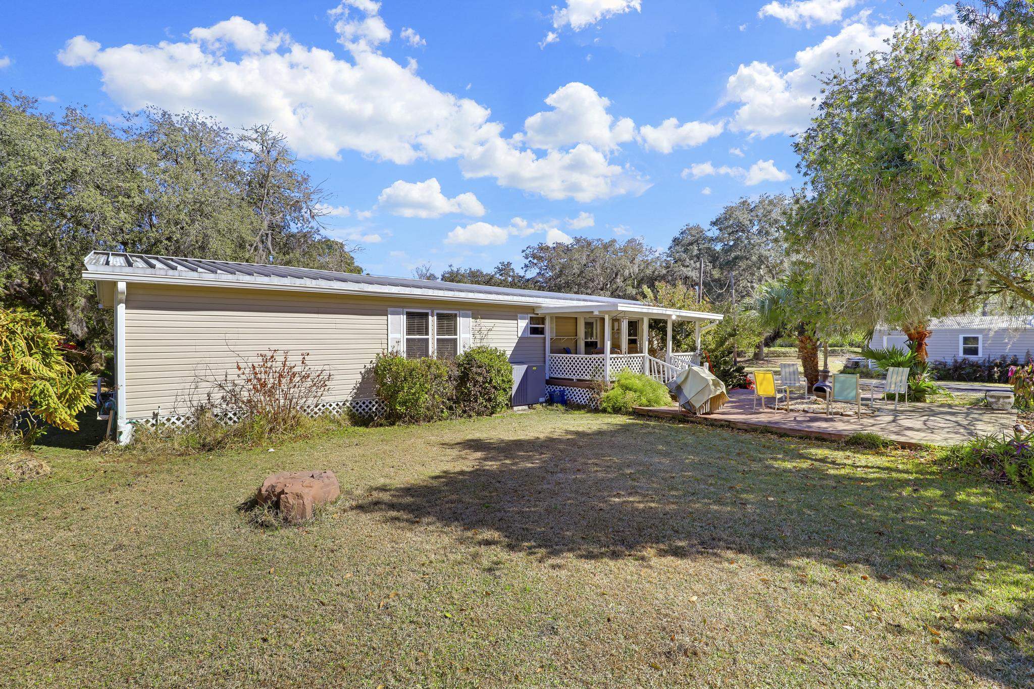 6901 Catlett Road St. Augustine, FL 32095 - Photo 53 of 74 View of front of property featuring a patio area, a metal roof, and a front yard