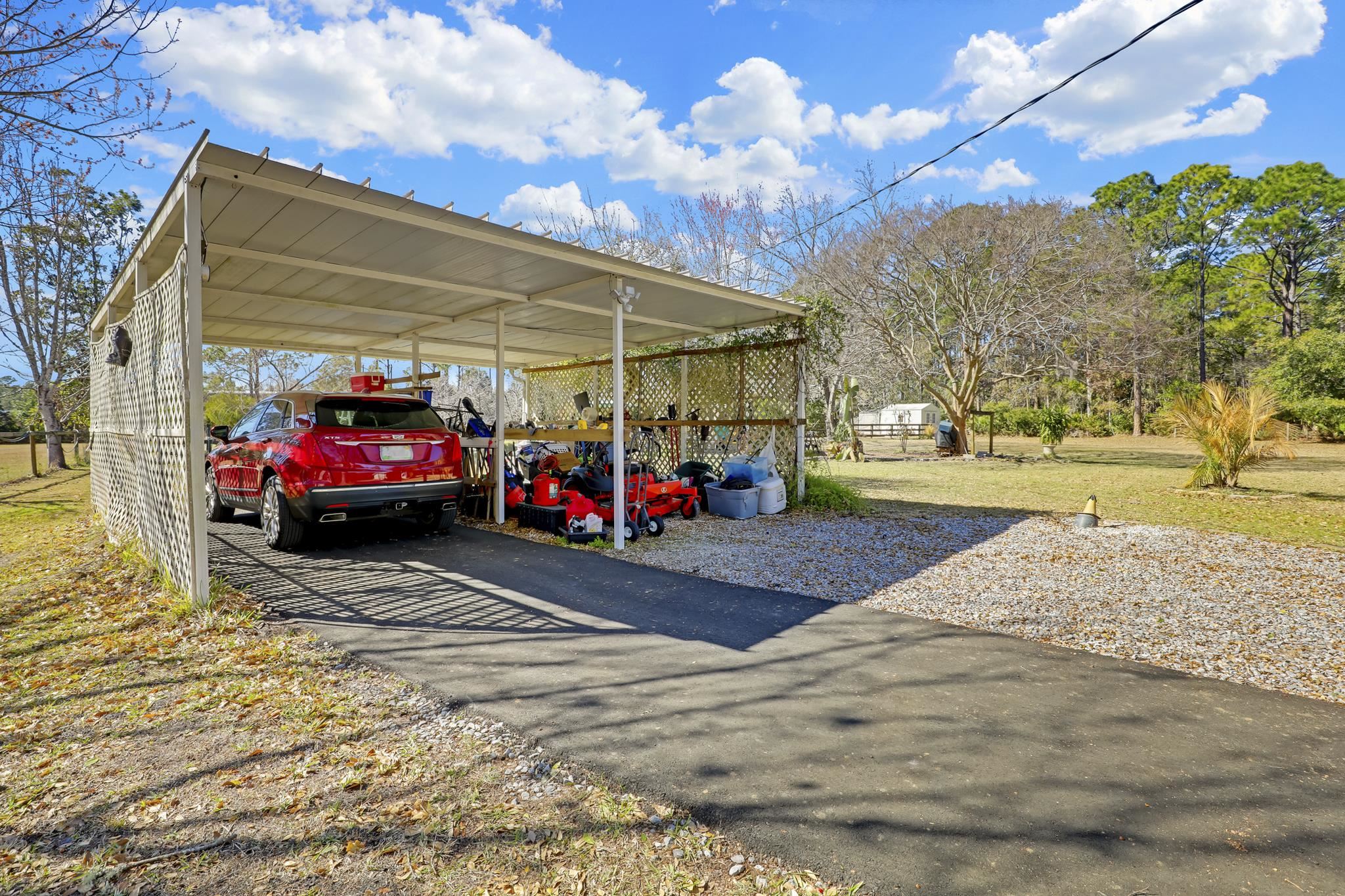 6901 Catlett Road St. Augustine, FL 32095 - Photo 62 of 74 View of parking featuring a detached carport and driveway