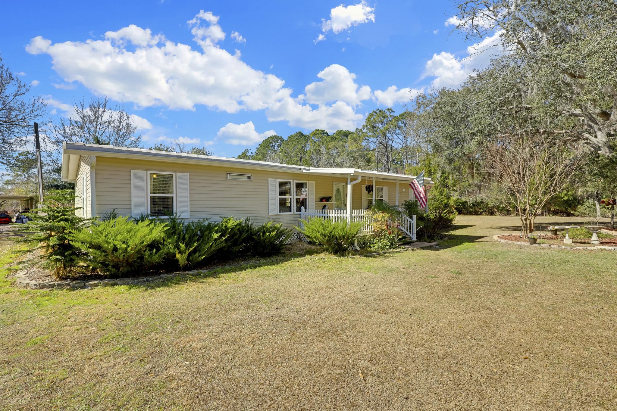 6901 Catlett Road St. Augustine, FL 32095 - Photo 74 of 74 View of front of home with a front yard and a porch