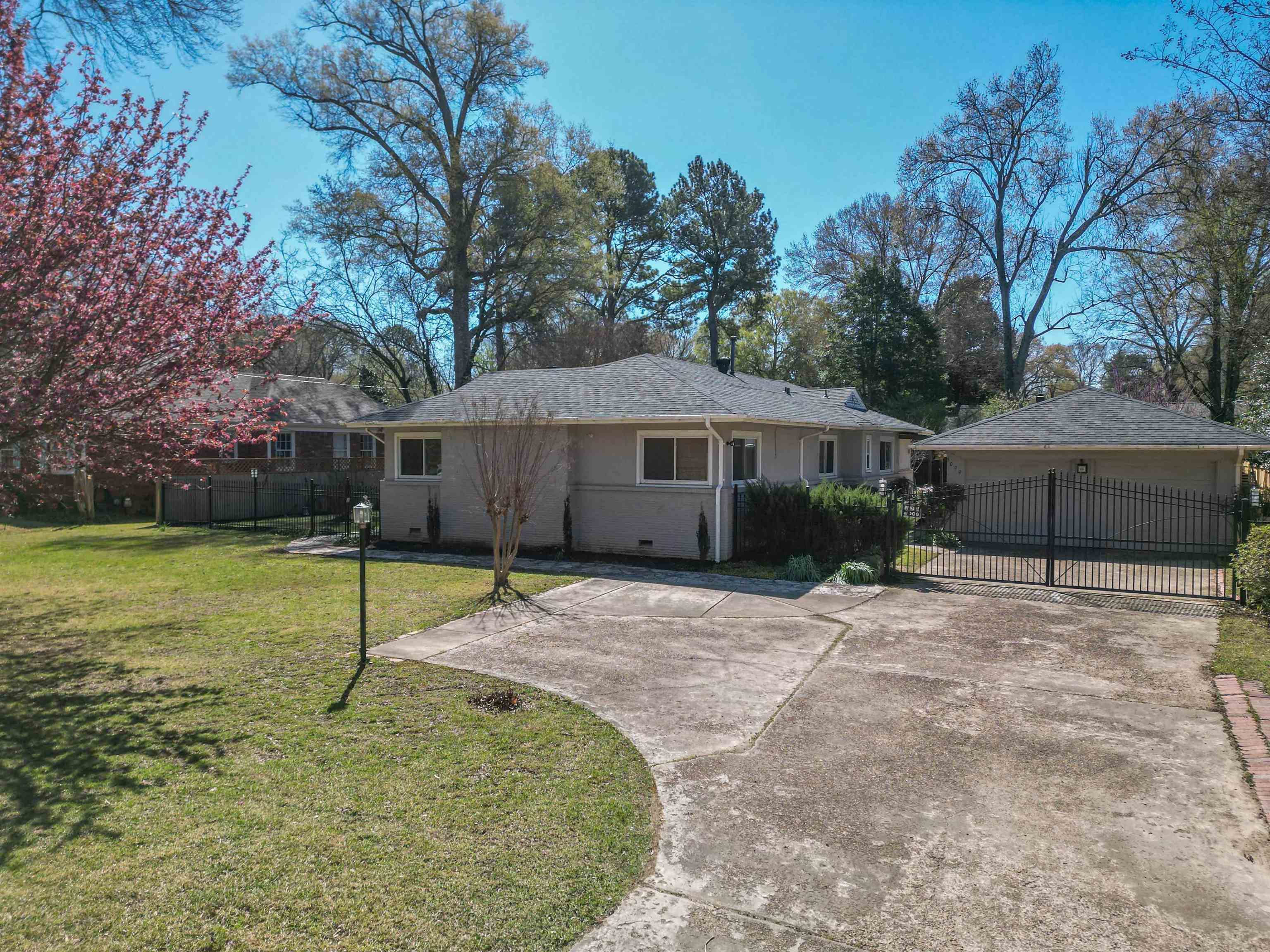 5099 Walnut Grove Road Memphis, TN 38117 - Photo 4 of 24 View of front of home with a garage, roof with shingles, and a gate