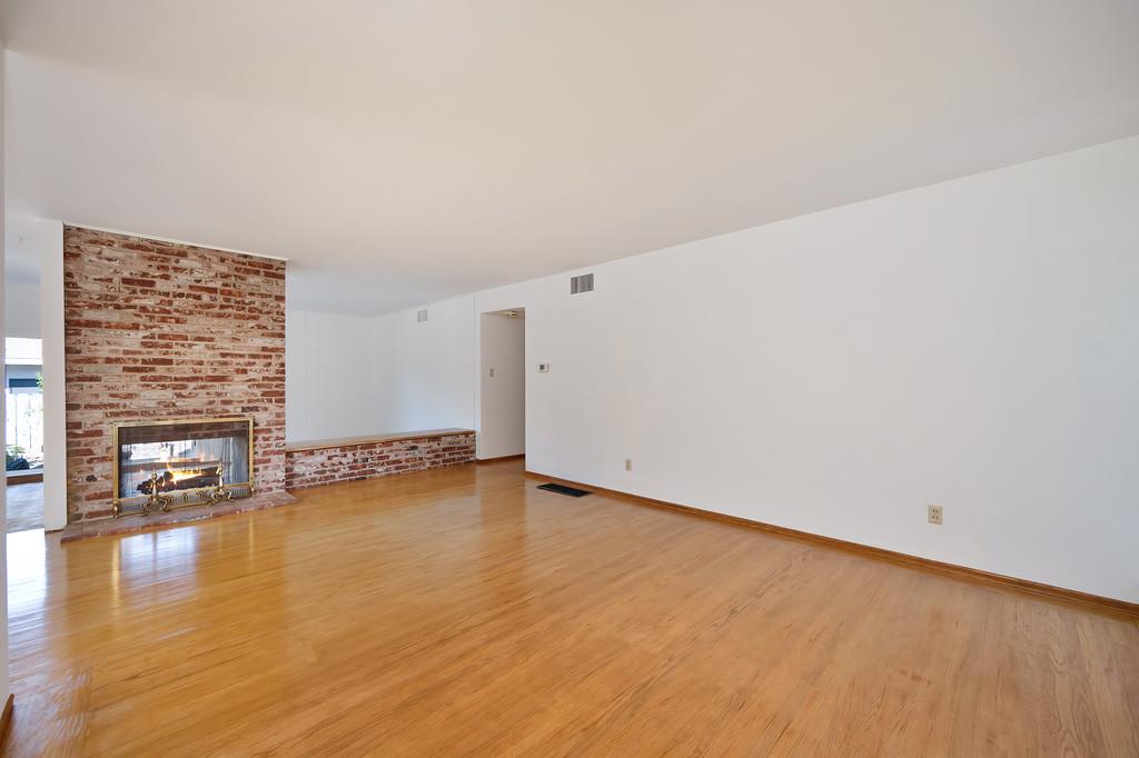1056 Entrada Road Sacramento, CA 95864 - Photo 13 of 57 a view of a room with wooden floor and a fireplace