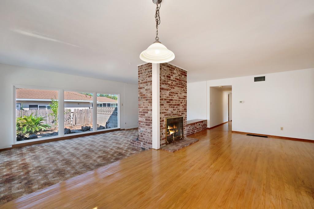 1056 Entrada Road Sacramento, CA 95864 - Photo 16 of 57 a view of an empty room with a window and wooden floor