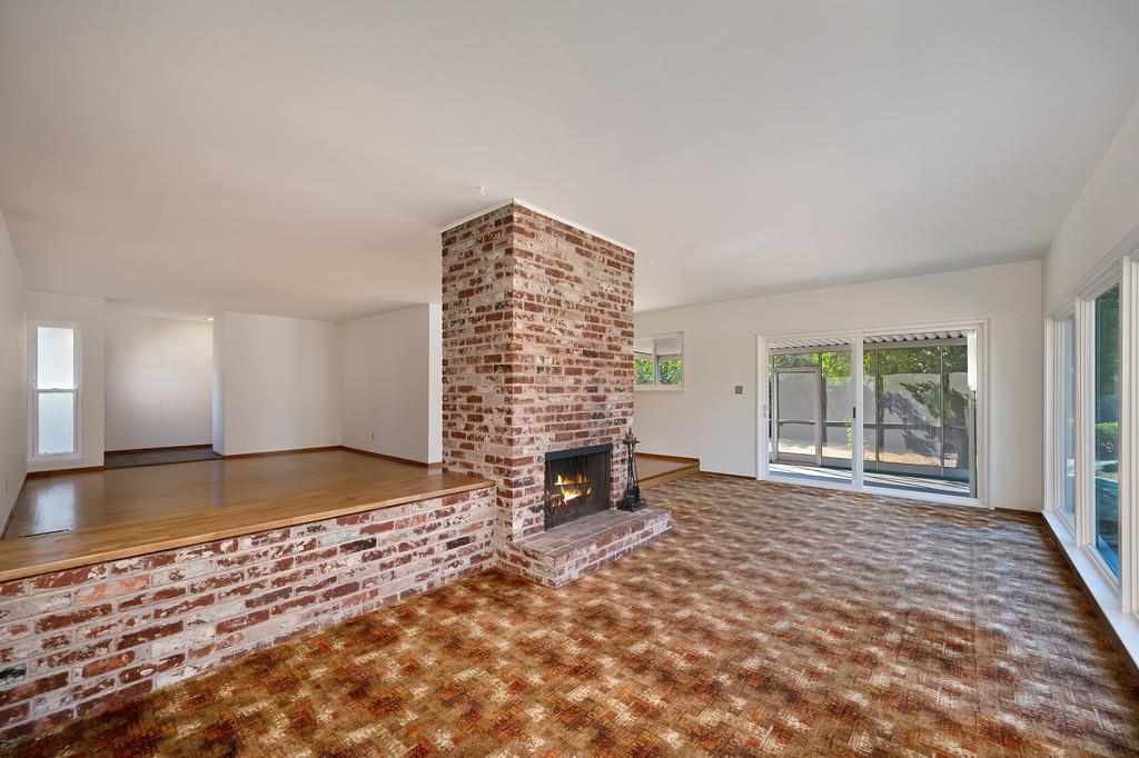 1056 Entrada Road Sacramento, CA 95864 - Photo 21 of 57 a view of an empty room with a fireplace and a window