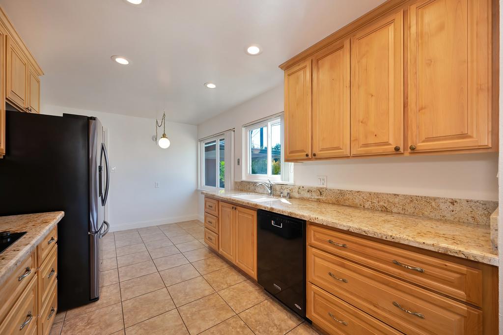 1056 Entrada Road Sacramento, CA 95864 - Photo 23 of 57 a kitchen with stainless steel appliances granite countertop a refrigerator and a sink