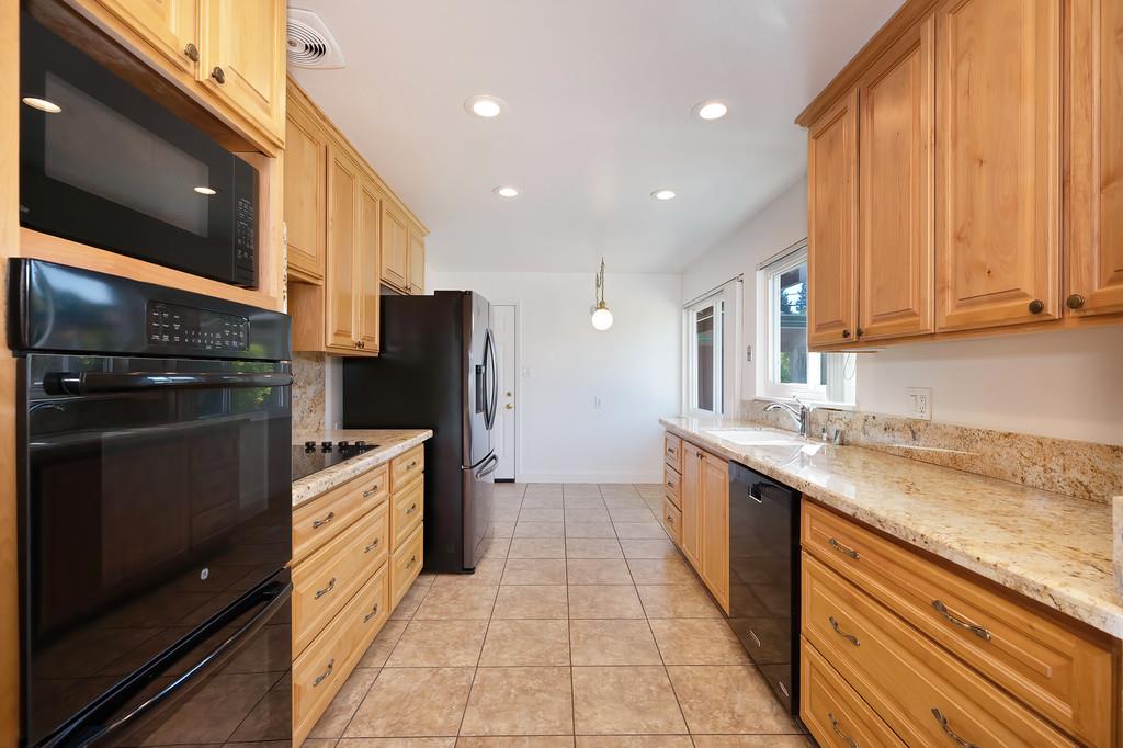 1056 Entrada Road Sacramento, CA 95864 - Photo 24 of 57 a large kitchen with stainless steel appliances granite countertop a stove a sink and a refrigerator