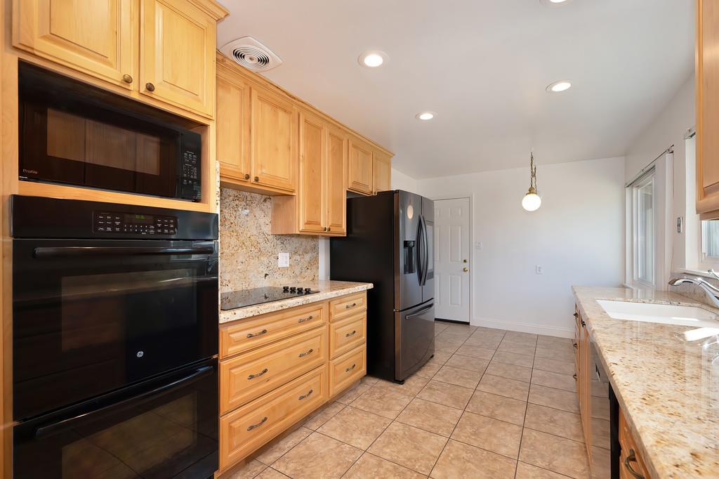 1056 Entrada Road Sacramento, CA 95864 - Photo 25 of 57 a kitchen with granite countertop cabinets and steel stainless steel appliances