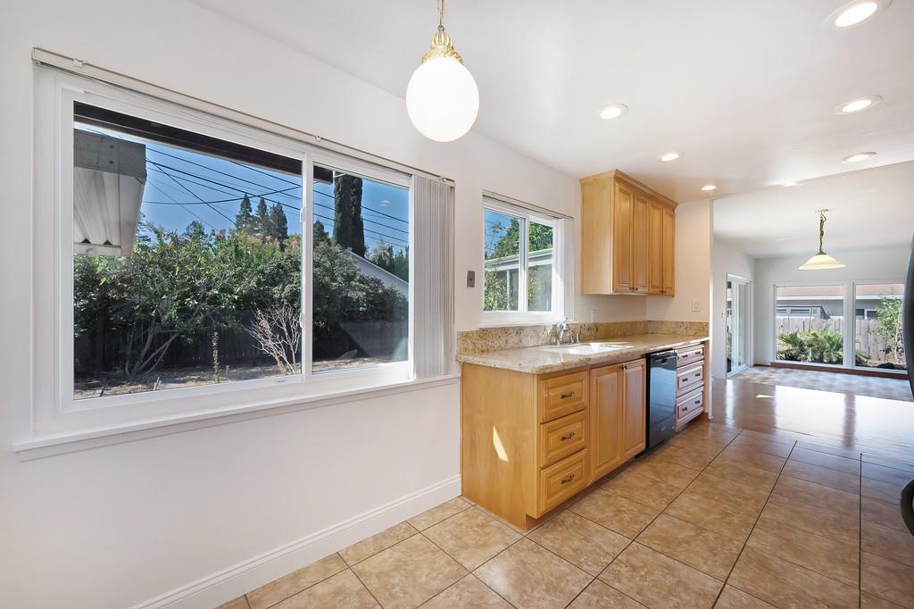 1056 Entrada Road Sacramento, CA 95864 - Photo 27 of 57 a kitchen with stainless steel appliances granite countertop a stove a sink and a microwave