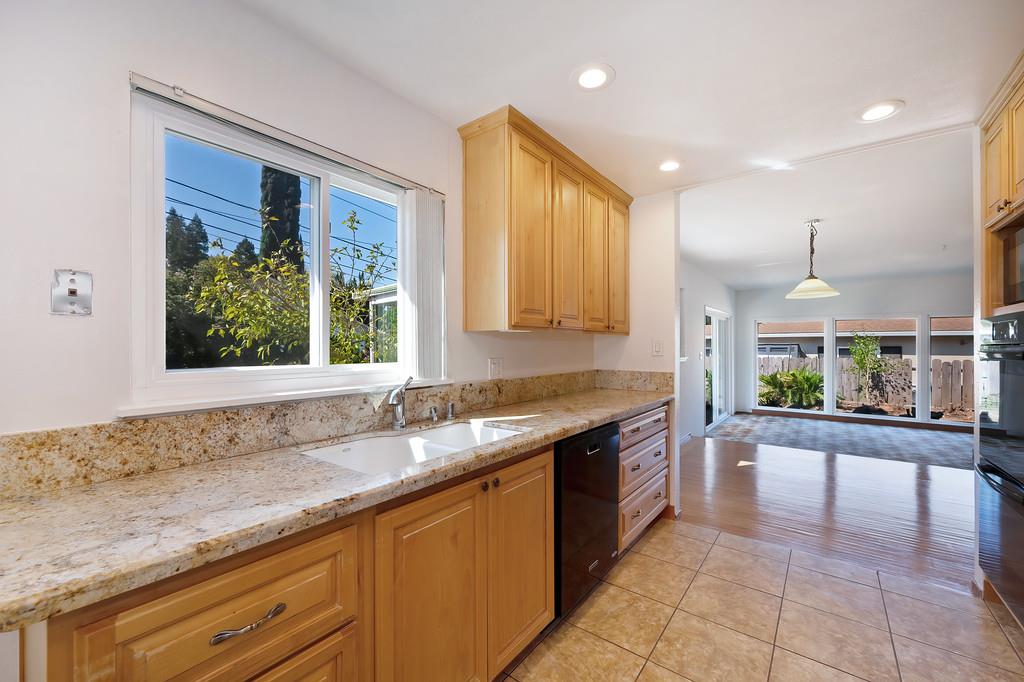 1056 Entrada Road Sacramento, CA 95864 - Photo 28 of 57 a large kitchen with granite countertop a sink and a stove