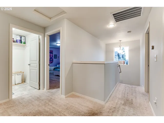 a view of a hallway and closet with bathroom
