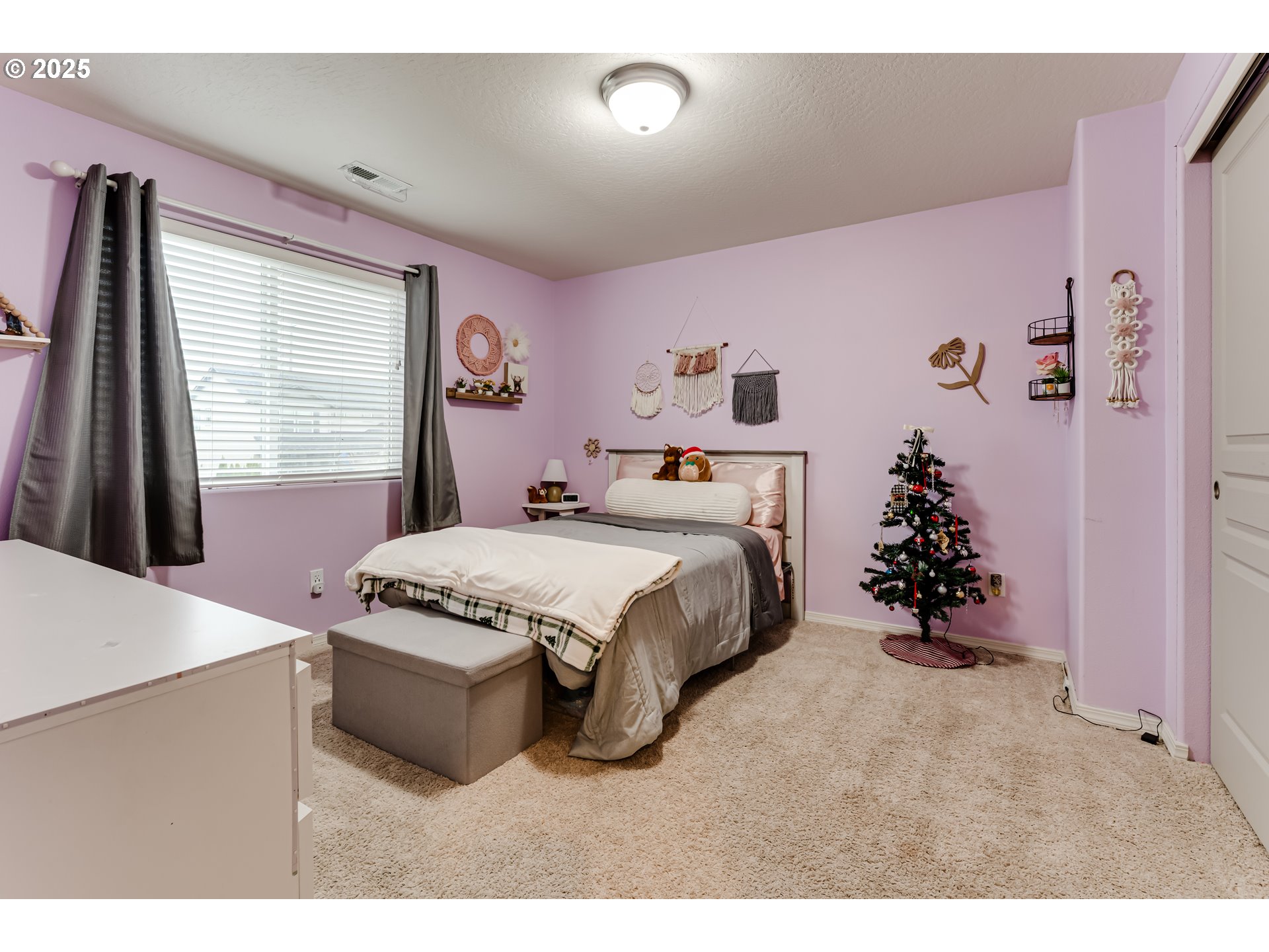 4685 Glacier Meadows Loop Springfield, OR 97478 - Photo 15 of 28 a spacious bedroom with a bed and a chandelier
