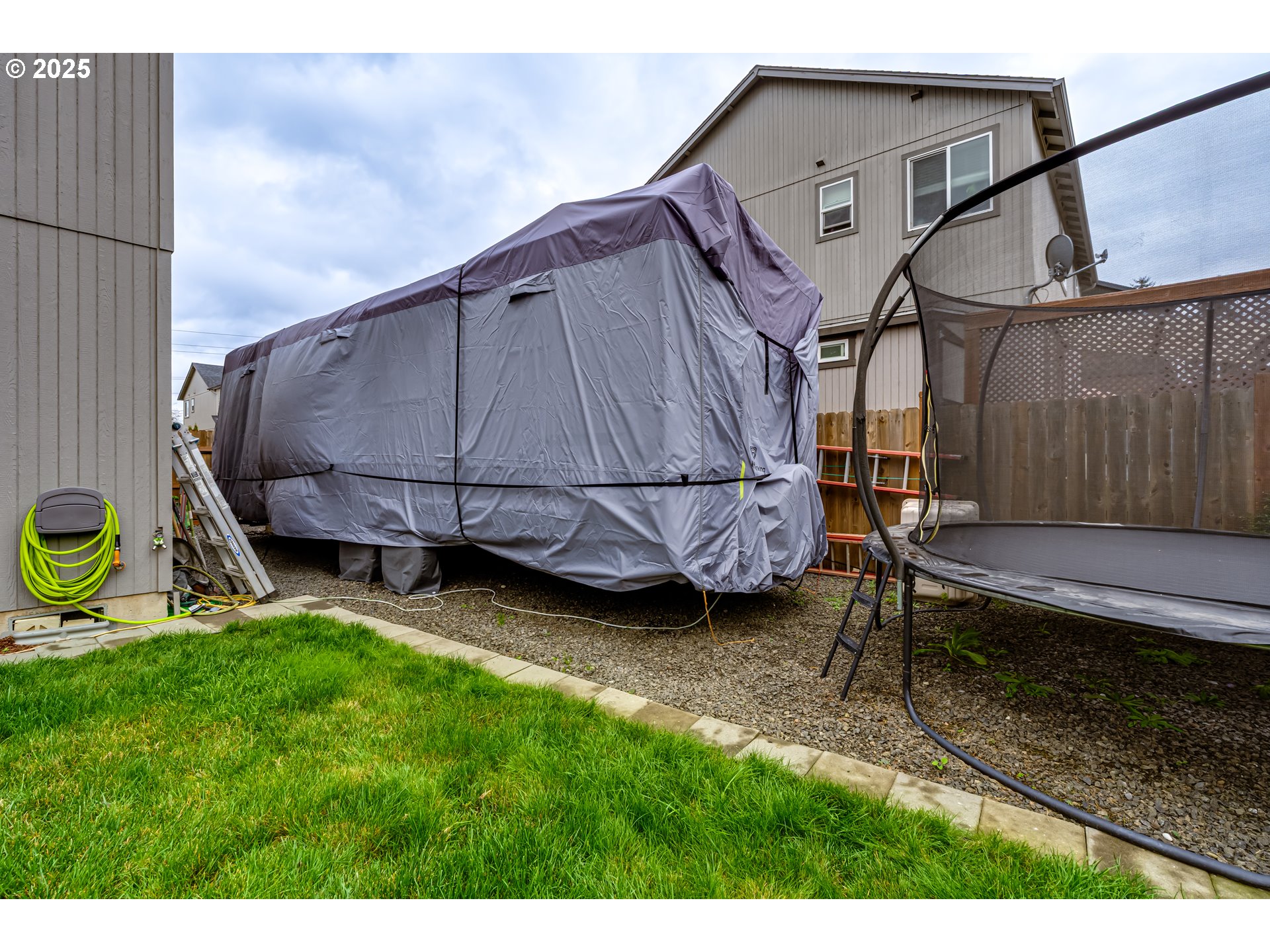 4685 Glacier Meadows Loop Springfield, OR 97478 - Photo 24 of 28 a backyard of a house with wooden floor and fence