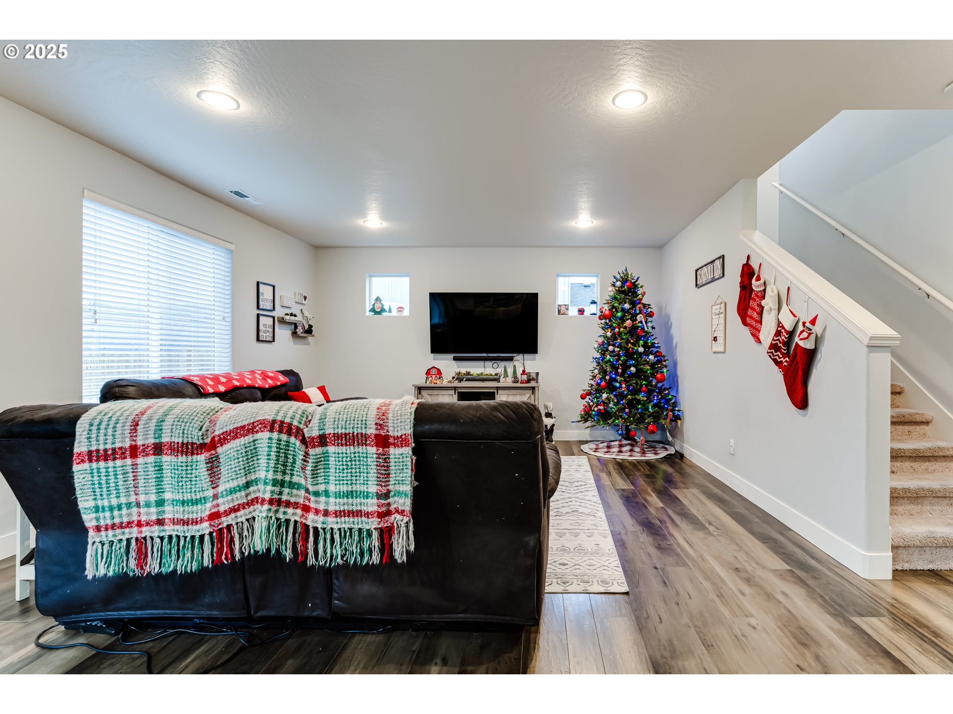 4685 Glacier Meadows Loop Springfield, OR 97478 - Photo 3 of 28 a living room with a bed furniture and a flat screen tv