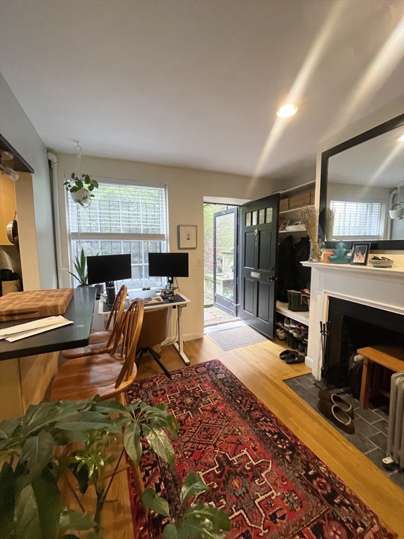 9 Primus Avenue, Unit 1 Boston, MA 02114 - Photo 1 of 19 a living room with furniture a fireplace and a flat screen tv