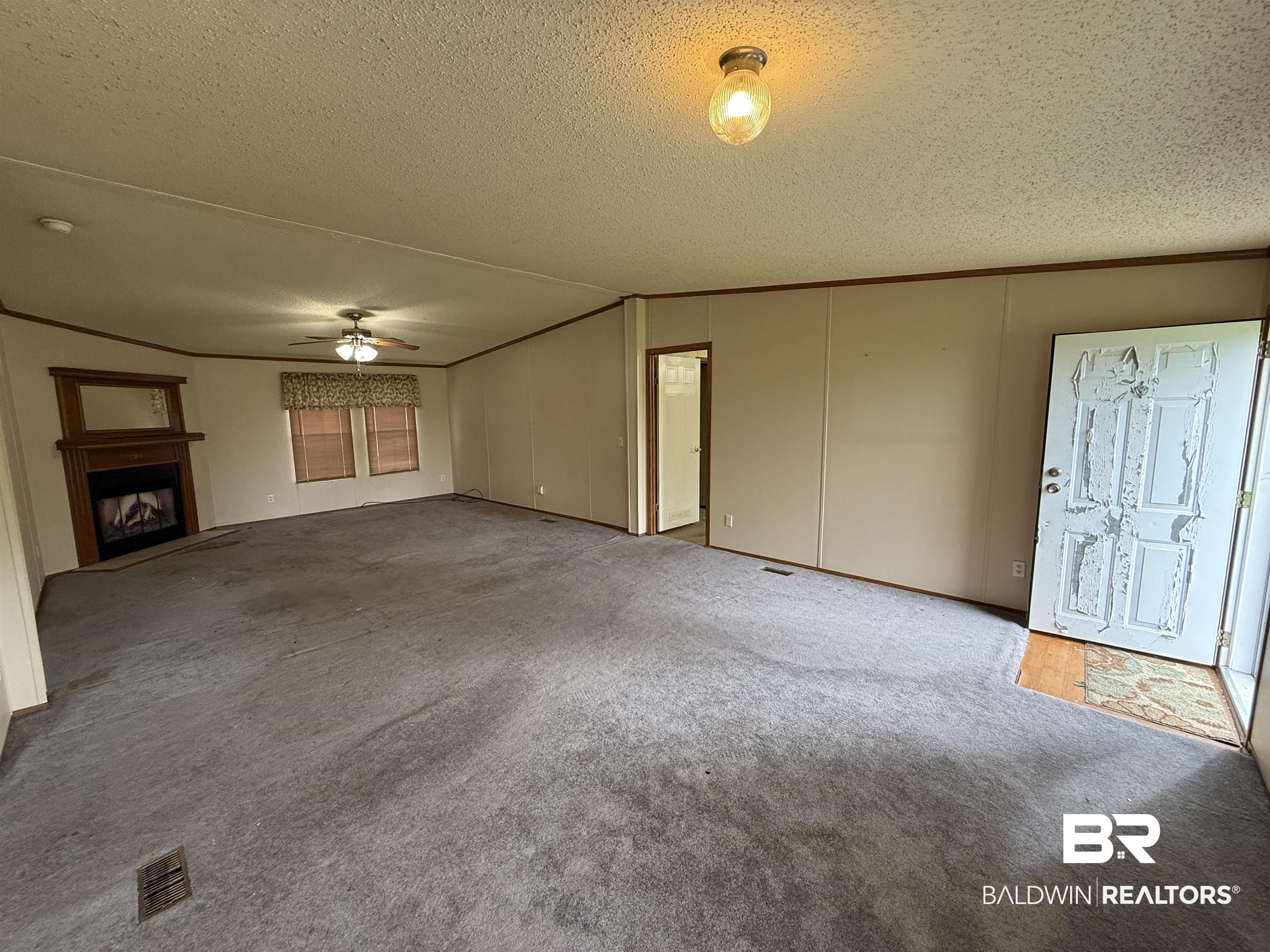 14402 County Road 55 Foley, AL 36535 - Photo 6 of 20 Unfurnished living room with carpet flooring, a textured ceiling, and ceiling fan