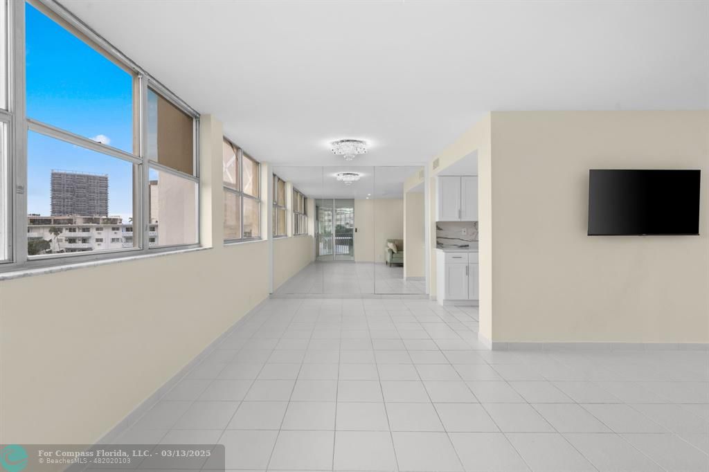 100 Golden Isles Drive, Unit 313 Hallandale Beach, FL 33009 - Photo 22 of 33 a view of an empty room and kitchen view