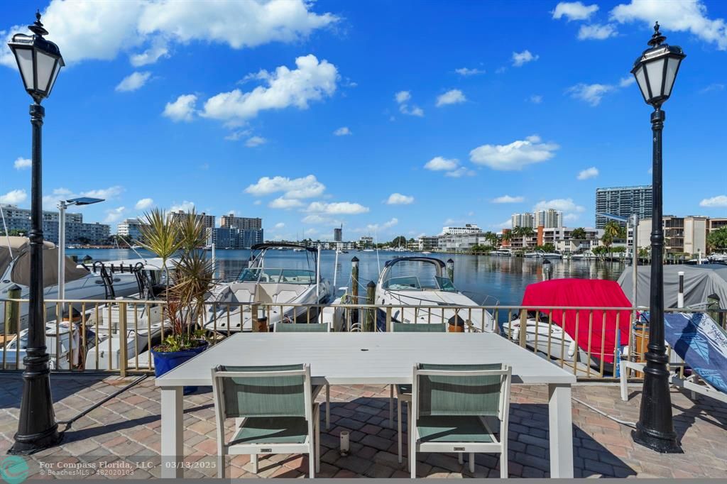 100 Golden Isles Drive, Unit 313 Hallandale Beach, FL 33009 - Photo 3 of 33 a view of a patio with swimming pool table and chairs
