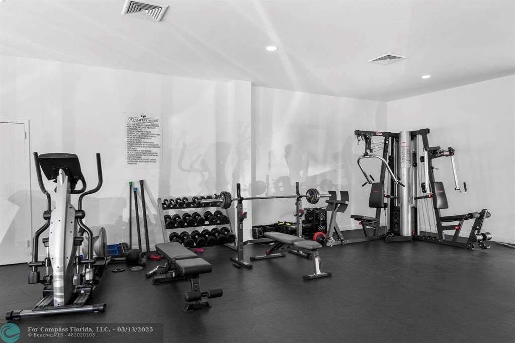 100 Golden Isles Drive, Unit 313 Hallandale Beach, FL 33009 - Photo 4 of 33 a view of a room with gym equipment