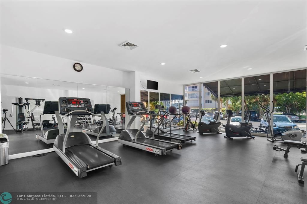 100 Golden Isles Drive, Unit 313 Hallandale Beach, FL 33009 - Photo 5 of 33 a view of a room with gym equipment