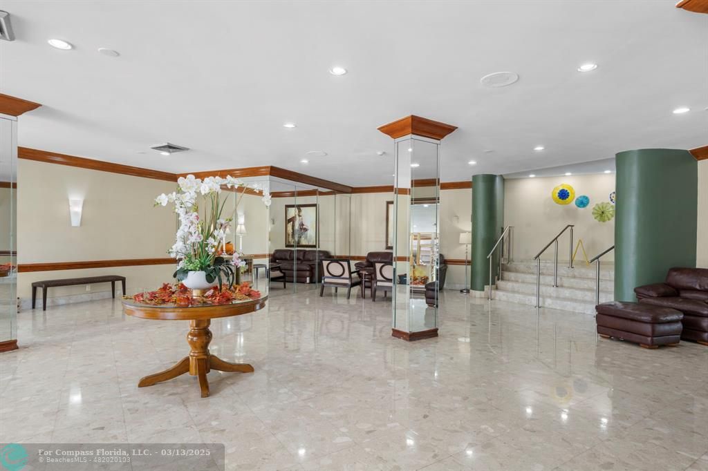 100 Golden Isles Drive, Unit 313 Hallandale Beach, FL 33009 - Photo 6 of 33 a view of a gym equipment and a chandelier