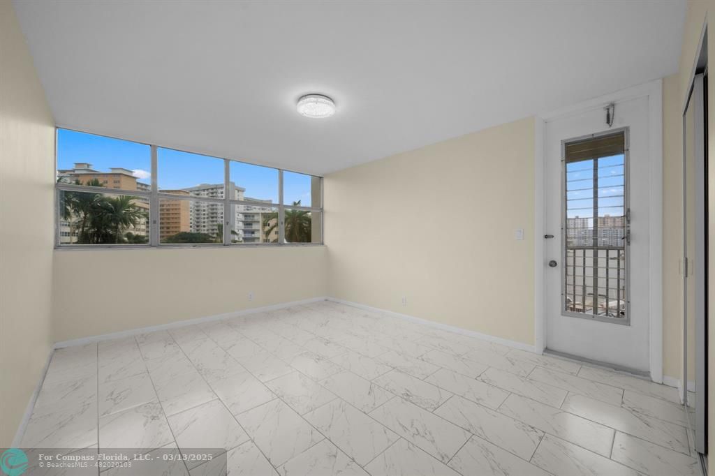 100 Golden Isles Drive, Unit 313 Hallandale Beach, FL 33009 - Photo 8 of 33 a view of a kitchen with a sink and a refrigerator